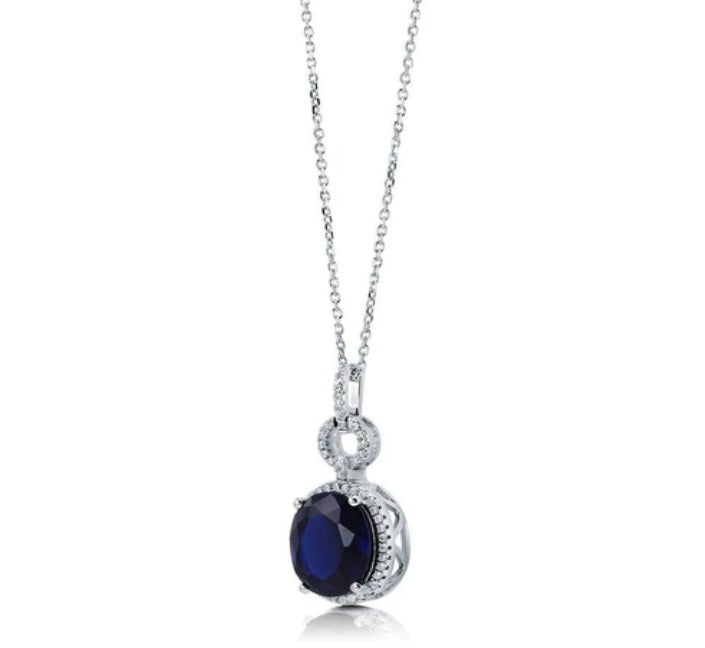 Halo Simulated Blue Sapphire Oval CZ Necklace in Sterling Silver