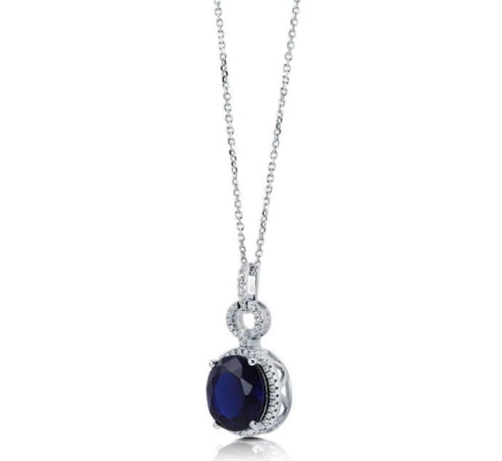 Halo Simulated Blue Sapphire Oval CZ Necklace in Sterling Silver